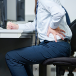 デスクワークの腰痛に苦しんでいる男性